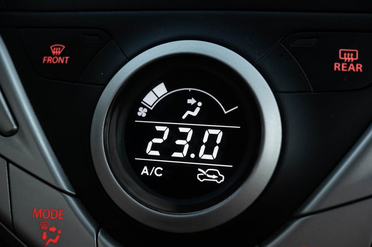 Close-up view of a car climate control system set to 23 degrees Celsius.